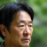 Portrait of Riku Sato, a Japanese man with a thoughtful expression.